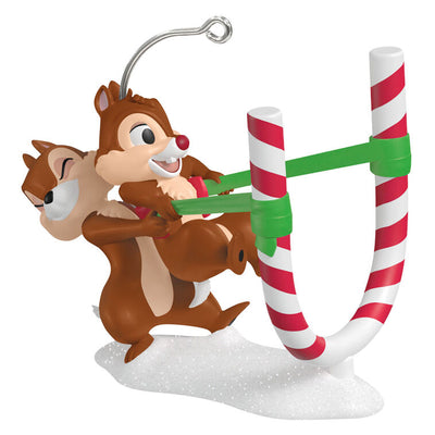 Chip launches Dale from a candy cane catapult in this playful Hallmark Keepsake Disney Christmas ornament with snowy base.