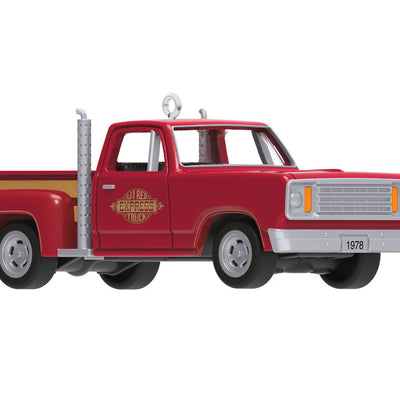 Miniature 1978 Dodge Li’l Red Express Christmas ornament in red and yellow with chrome stacks and turning wheels.