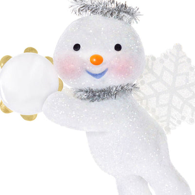 Glittery snow angel snowman ornament with tinsel halo, snowflake wings, rosy cheeks, and holding a tambourine

