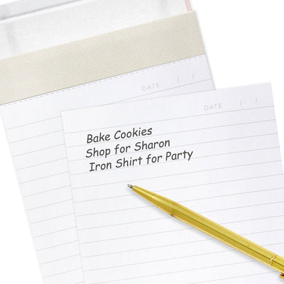 Pastel pink faux leather list pad with gold foil honeycomb design and lined, perforated pages.

