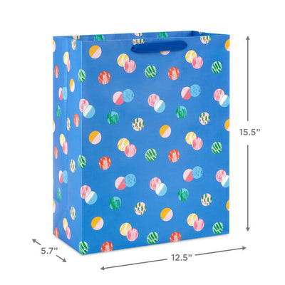 Hallmark extra-large gift bag with playful polka dots on a blue background, ideal for birthdays, holidays, or celebrations.