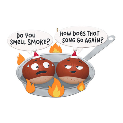 Funny Christmas ornament with two chestnuts roasting in a flaming skillet.

