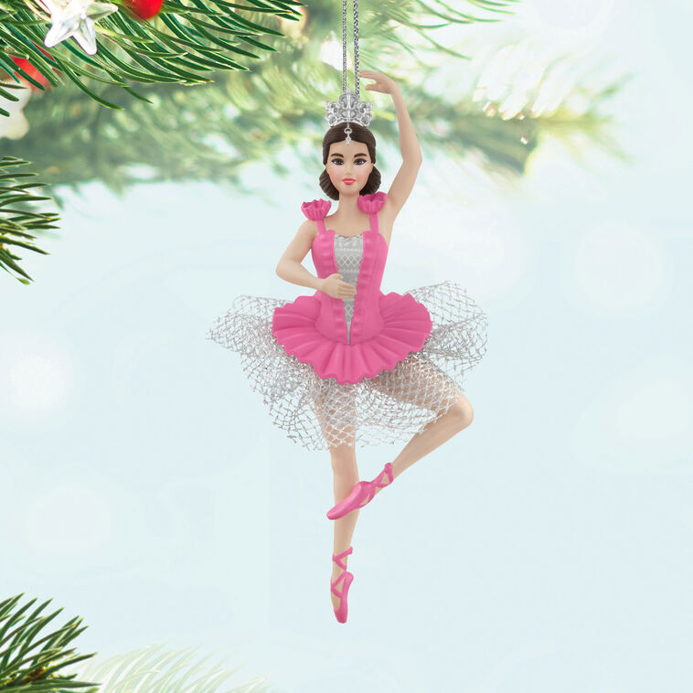 Barbie ballerina Christmas ornament wearing a pink tutu, pointe shoes, and silver tiara, posed en pointe with arm raised in a graceful ballet position.