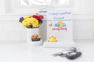 Nora Fleming sun-shaped mini with a smiling face; cheerful yellow accent for summer entertaining; hand wash only.

