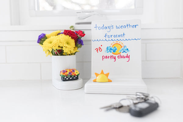 Nora Fleming sun-shaped mini with a smiling face; cheerful yellow accent for summer entertaining; hand wash only.

