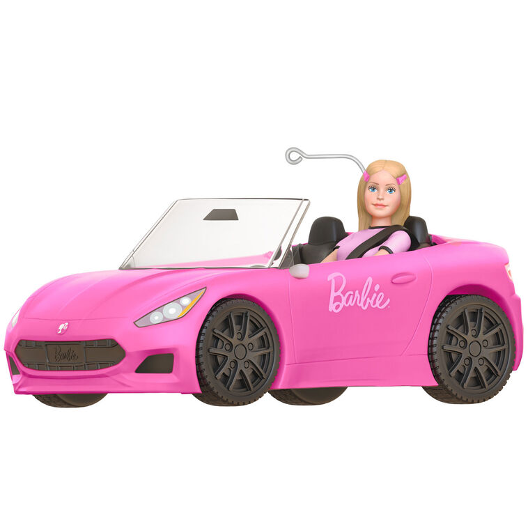 Barbie ornament driving a pink convertible sports car, wearing pink tee and barrettes, Hallmark Keepsake holiday decoration.