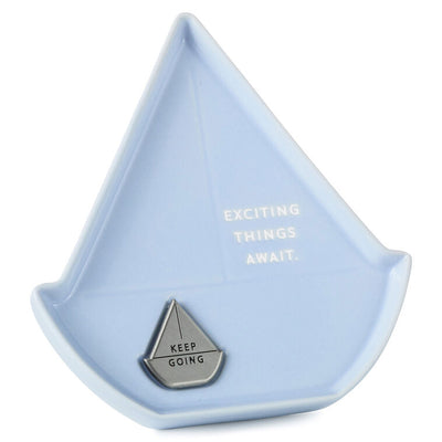 Light blue sailboat-shaped Hallmark trinket dish with removable “Keep going” token and inspiring message.