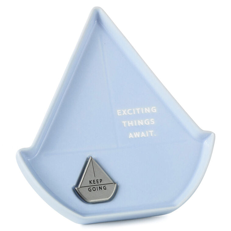 Light blue sailboat-shaped Hallmark trinket dish with removable “Keep going” token and inspiring message.