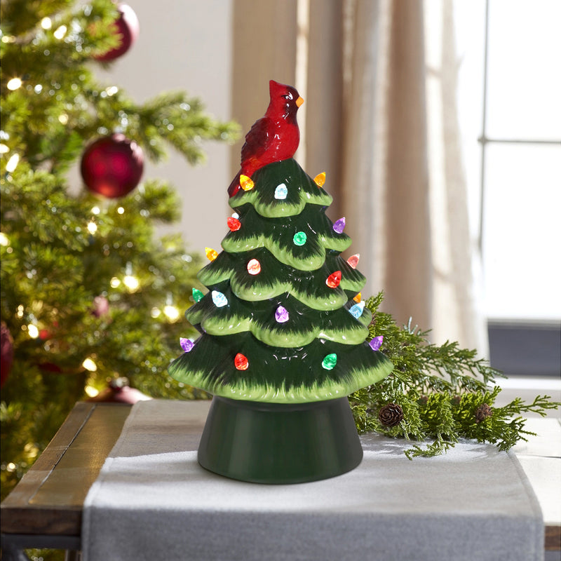 Glossy green ceramic LED Christmas tree with multicolor lights and red cardinal bird topper.