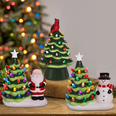 Glossy green ceramic LED Christmas tree with multicolor lights and red cardinal bird topper.