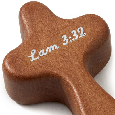 Hallmark remembrance cross with white dove and “Lam 3:32” printed on dark stained wood.