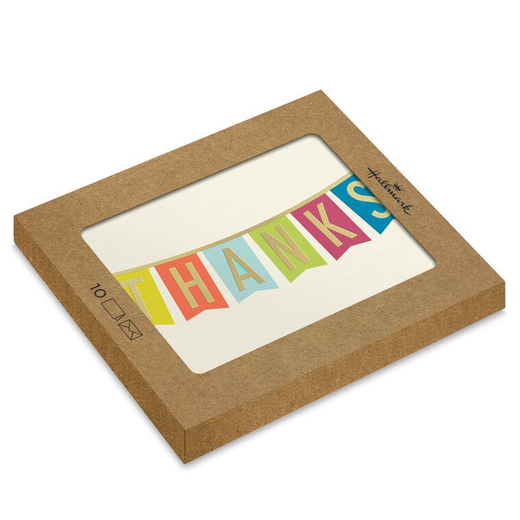 Thank-you cards with colorful pennant banner letters and gold foil on an off-white background.
