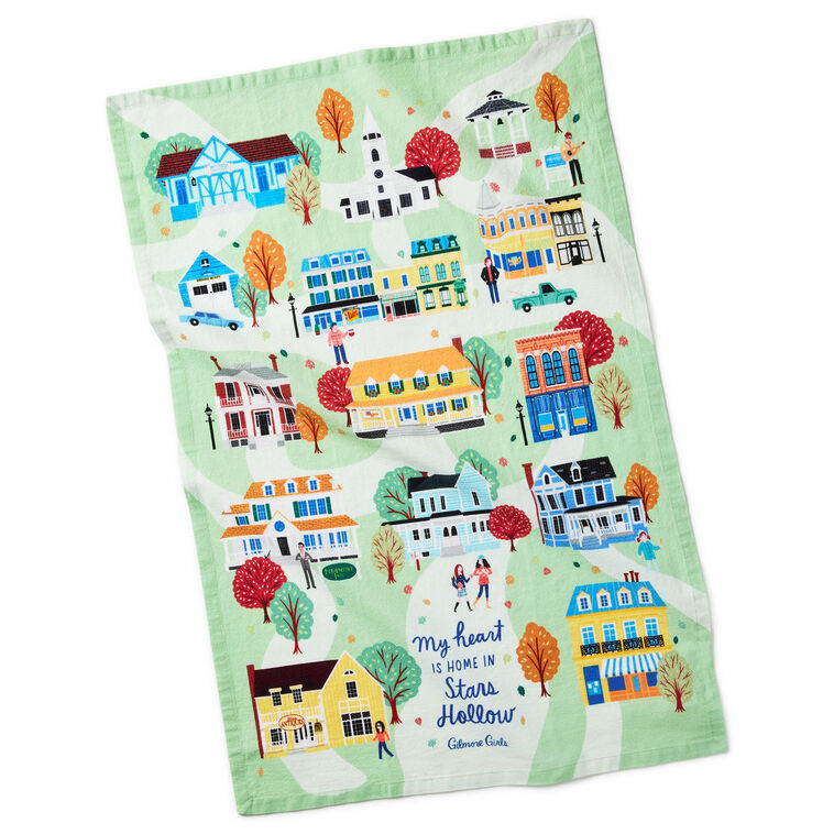 White tea towel printed with a whimsical Stars Hollow map and a central Gilmore Girls quote, includes a loop for hanging.

