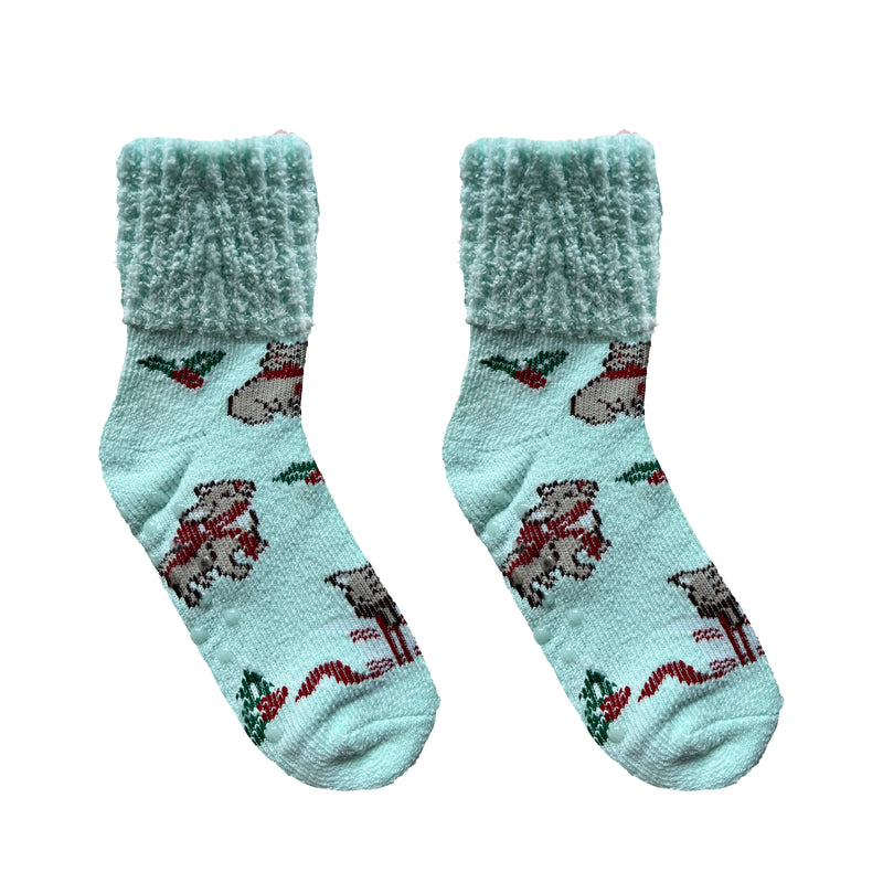 Assorted fuzzy socks in pink, teal, and neutral tones with cocoa mugs and snowflake patterns.