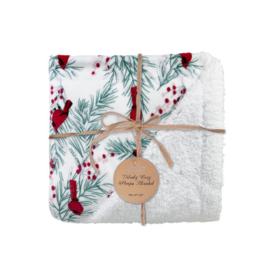 White fleece Sherpa blanket with red cardinals, holly, and pine branches on soft velvety fabric.