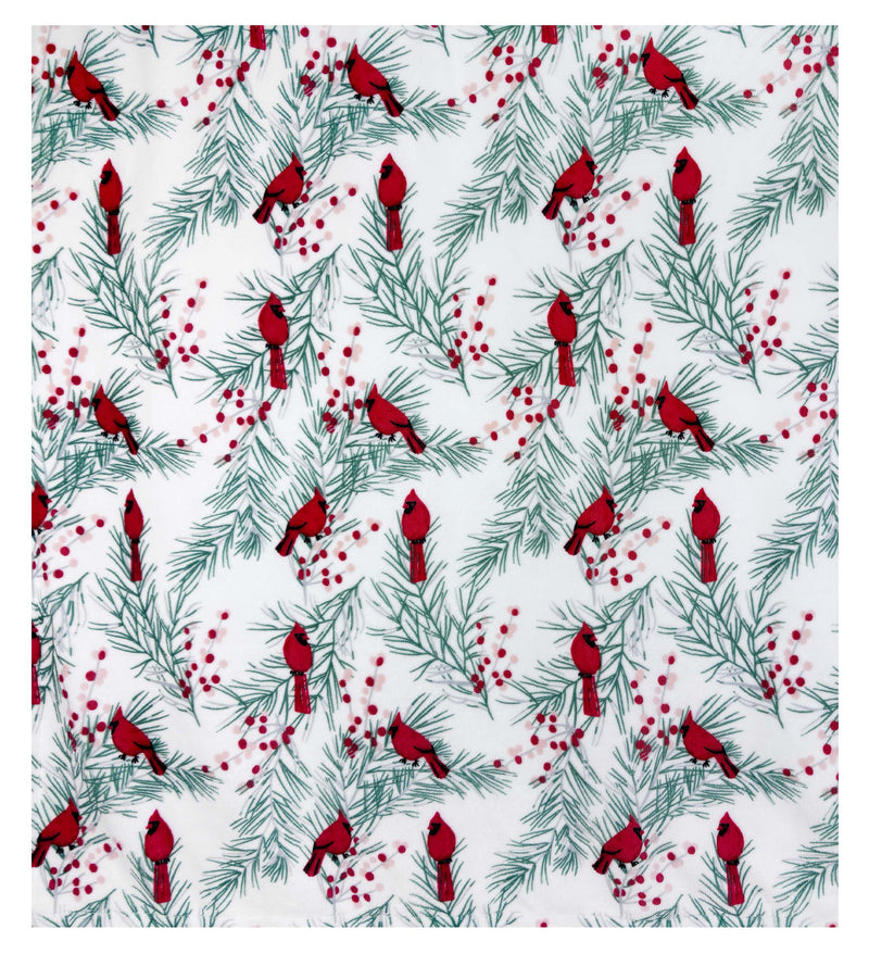 White fleece Sherpa blanket with red cardinals, holly, and pine branches on soft velvety fabric.