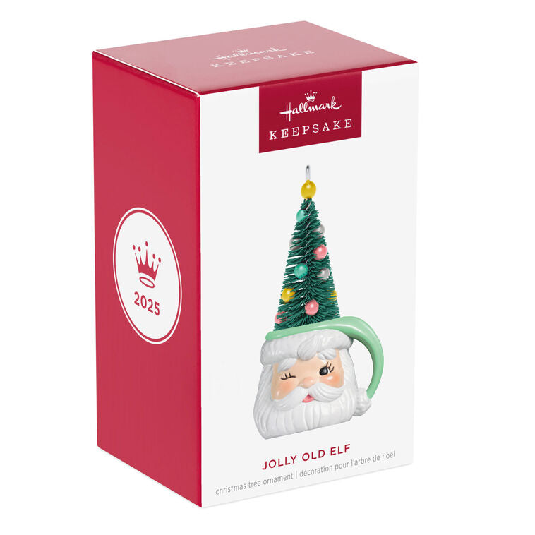 Green stocking hat mug ornament with winking Santa face and pastel ball-decorated bottlebrush tree inside

