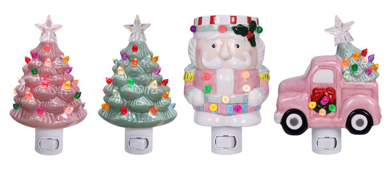 Assorted ceramic night lights with sugarplum designs including pink Christmas trees, Santa, and a festive red truck.