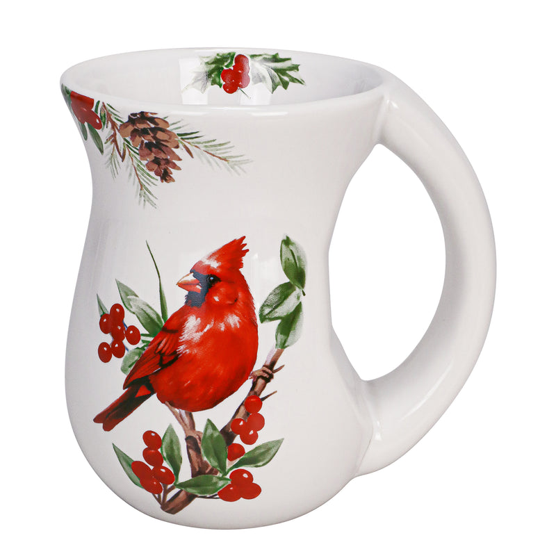 White ceramic mug with red cardinal perched on holly branches, curved body and comfort-grip handle.