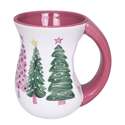 White ceramic mug with pink interior and pastel green and pink Christmas tree designs, flared body and handle.