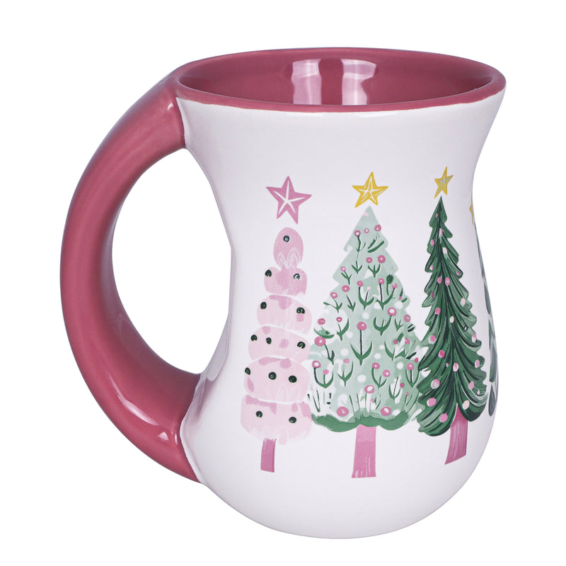 White ceramic mug with pink interior and pastel green and pink Christmas tree designs, flared body and handle.