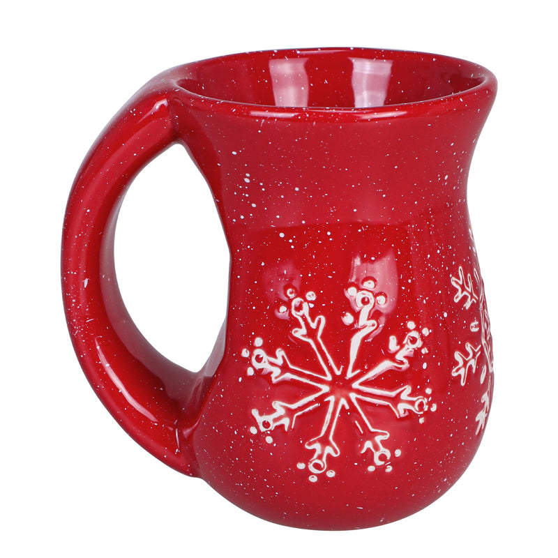 Cranberry red ceramic mug with white snowflake pattern and rounded body with large handle.
