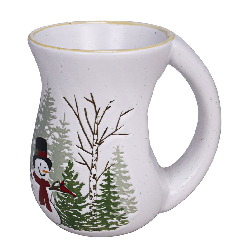 White ceramic mug with balsam and cedar tree artwork and a smiling snowman illustration, curved shape and handle.