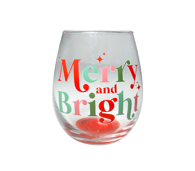 Clear stemless wine glass with red and green “Merry and Bright” lettering and festive holiday accents.