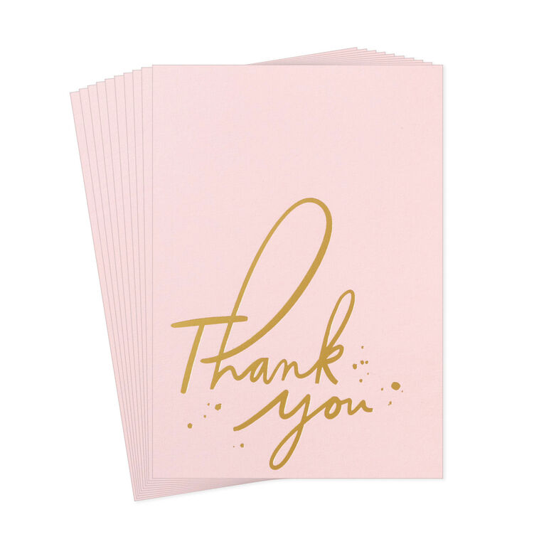 Pink thank-you cards with gold foil script and looped lettering, featuring delicate gold flecks.
