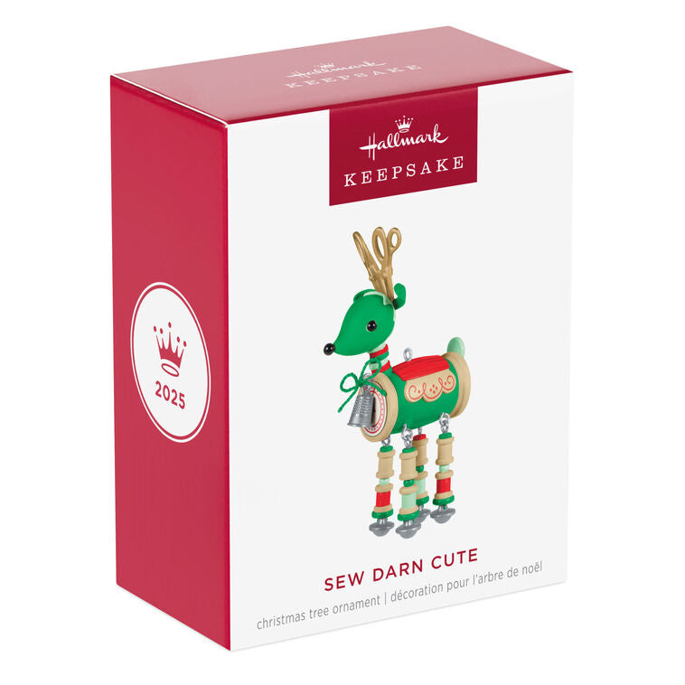 Green reindeer ornament made of red and green thread spools with gold scissors antlers, button tail, and silver thimble bell

