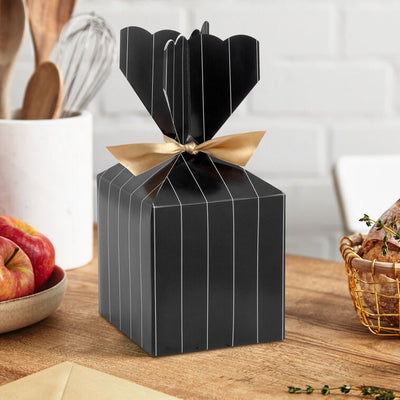 Hallmark vertical treat box with black and gold pinstripes, scalloped top, and gold ribbon tie—perfect for elegant gifts or party favors.