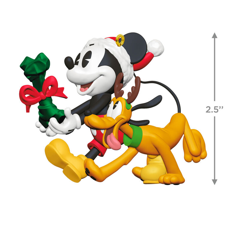Mickey Mouse holding a dog bone gift walks beside Pluto in reindeer antlers in this cheerful Disney Hallmark Christmas ornament.