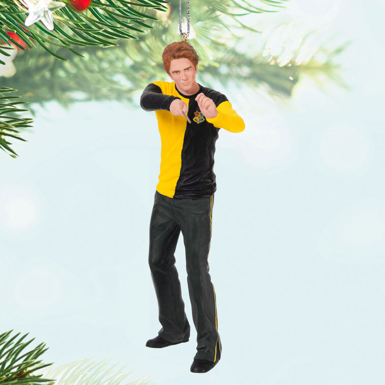 Cedric Diggory in yellow and black Hufflepuff robes raising his wand in a Harry Potter Christmas tree ornament