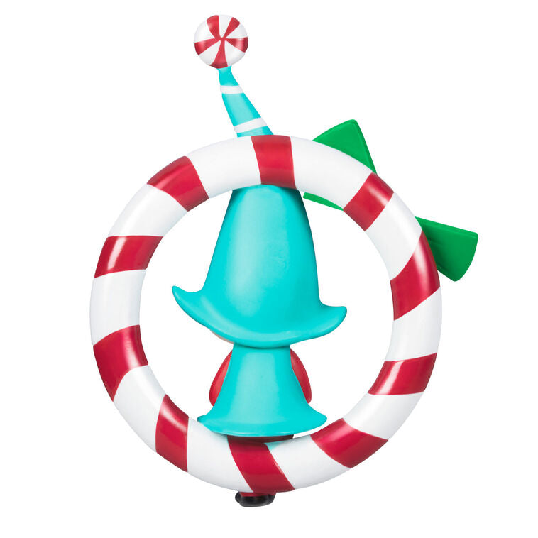 Hallmark Keepsake Sweet Peppermint girl gnome ornament in red and blue, sitting on candy cane wreath with green bow.