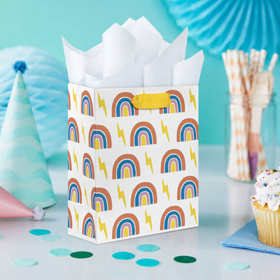 Small Hallmark gift bag with colorful rainbows and yellow lightning bolts on a white background with yellow ribbon handles.