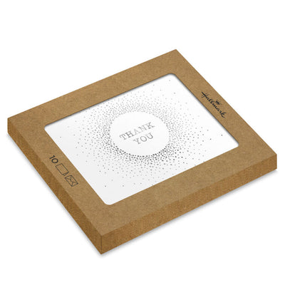 White thank-you cards with silver foil dots radiating from center text and matching envelopes.
