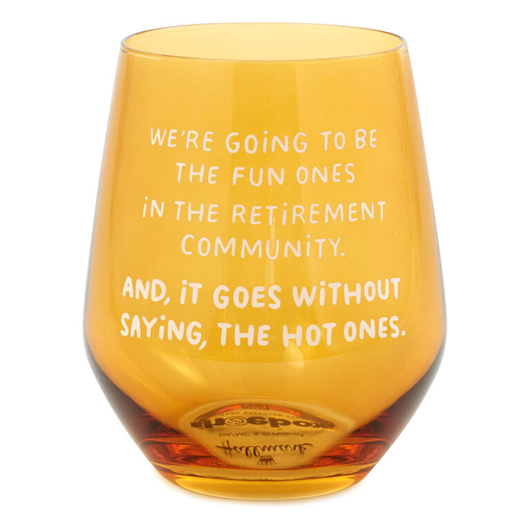 Amber-tinted stemless wine glass with white text: “We&