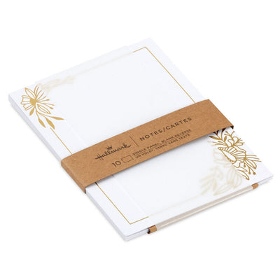 White flat note cards with gold foil corner floral swags and kraft band packaging.
