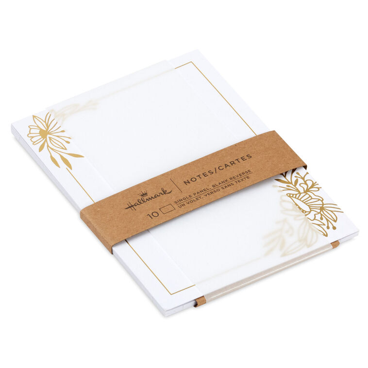 White flat note cards with gold foil corner floral swags and kraft band packaging.

