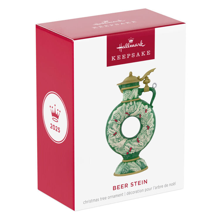 Green beer stein ornament with vintage wreath design, holly, and pinecones; features a gold lid and elegant holiday detailing.