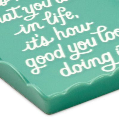 Teal Hallmark trinket tray with scalloped edge and message “It’s not what you do in life, it’s how good you look doing it.”