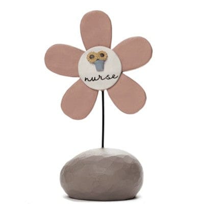 A whimsical resin flower figurine labeled “Nurse” in neutral tones, designed by Barbara Lloyd.
