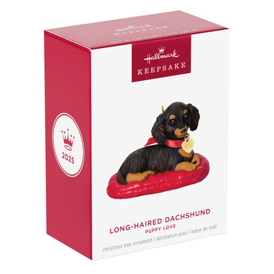 Hallmark Keepsake ornament of long-haired dark and light brown dachshund on red dog bed, red bow with 2025 heart charm