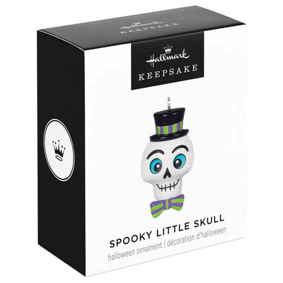 Mini Halloween skull ornament wearing sparkly top hat and bow tie with purple and green accents

