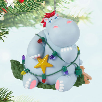 Hippopotamus Christmas ornament tangled in lights on a squished tree, plays holiday song, battery operated

