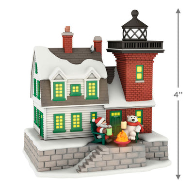Hallmark Keepsake ornament of a brick lighthouse and home with Santa and polar bear, glowing windows and beacon, Holiday Lighthouse 2025