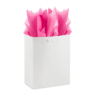 Hot pink Hallmark tissue paper with shimmering iridescent dots, displayed folded and fluffed in a gift bag.