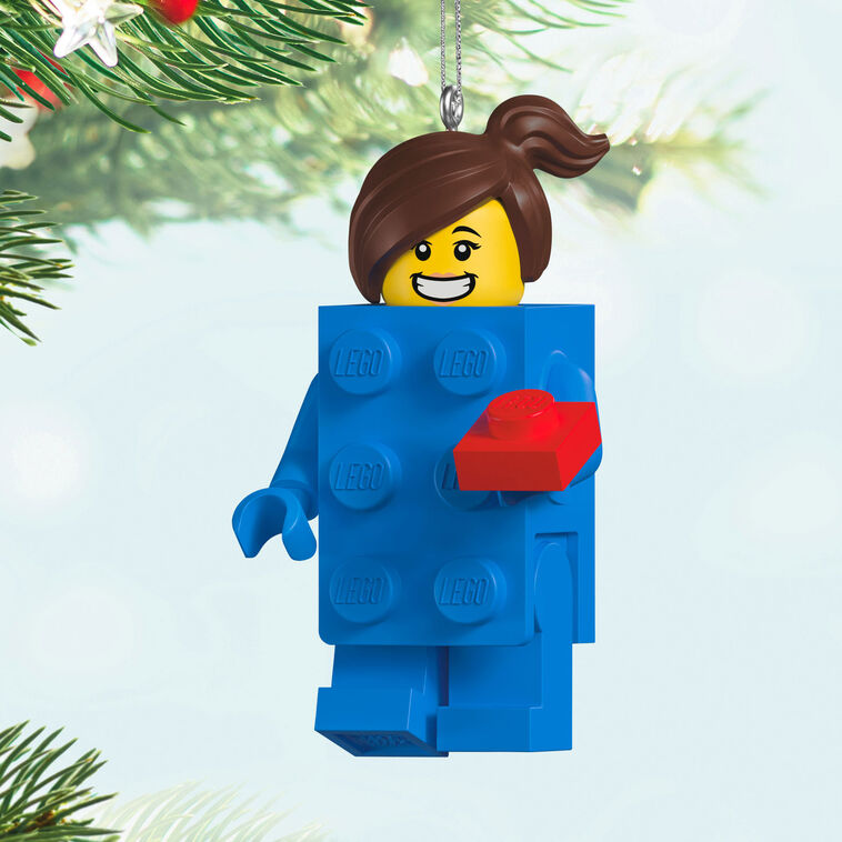 LEGO minifigure ornament with blue brick body, red piece in hand, and smiling brunette girl face.