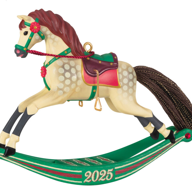 Hallmark Keepsake Rocking Horse Memories 2025 ornament—cream horse, brown mane and tail, red saddle, green sled base, red flower accents, year dated
