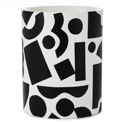 Round ceramic pencil caddy with bold black geometric shapes on a white background.
